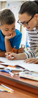 Teacher helping a child learn