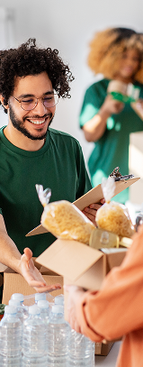 Volunteer at a food bank handing out supplies