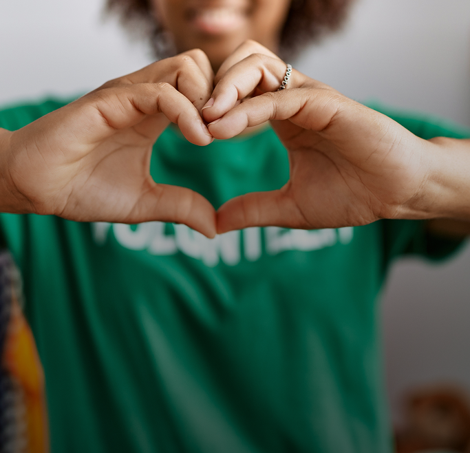 Volunteer making a heart shape